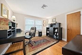 home office with hardwood / wood-style floors