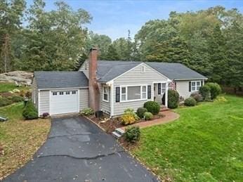 ranch-style house with a front yard and a garage