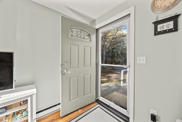 foyer entrance featuring hardwood / wood-style floors and baseboard heating