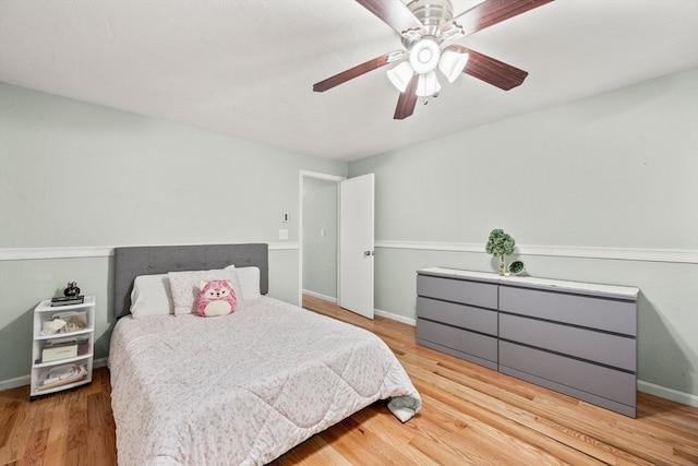 bedroom with ceiling fan and light hardwood / wood-style floors