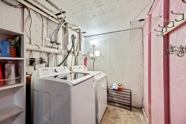 clothes washing area with washer and clothes dryer