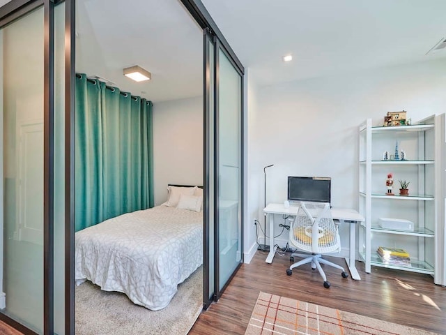 bedroom with dark wood-type flooring