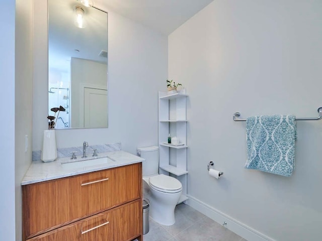 bathroom with tile patterned floors, vanity, and toilet