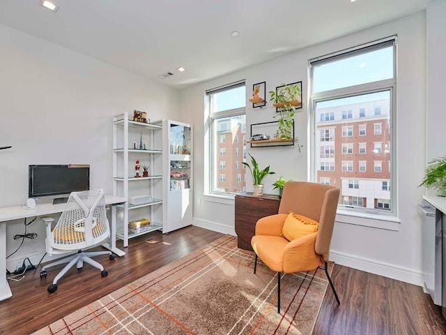 office space featuring dark hardwood / wood-style floors and radiator