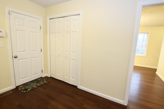 corridor with dark hardwood / wood-style floors