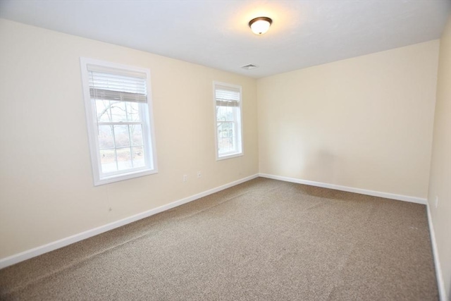 carpeted spare room with a healthy amount of sunlight