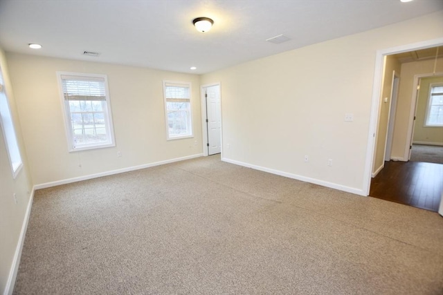 carpeted empty room with a wealth of natural light