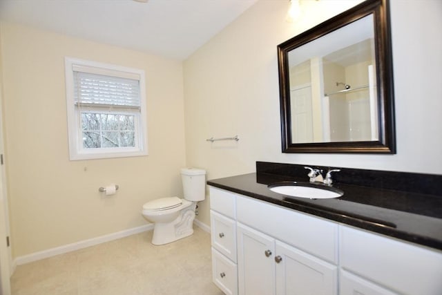 bathroom featuring a shower, tile patterned flooring, vanity, and toilet