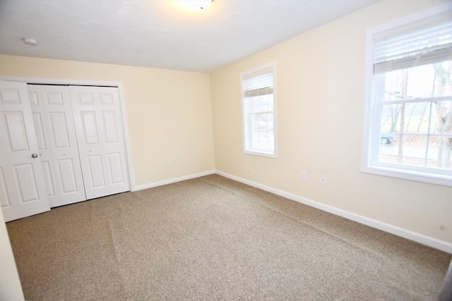 unfurnished bedroom featuring carpet flooring and a closet