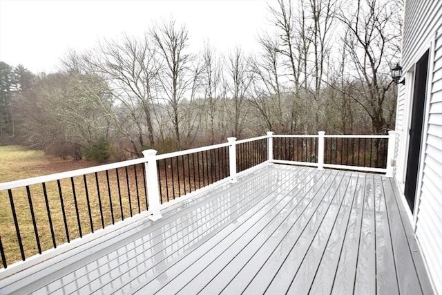 wooden deck with a lawn