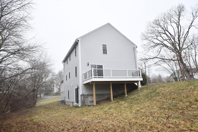 back of house featuring a yard and a deck