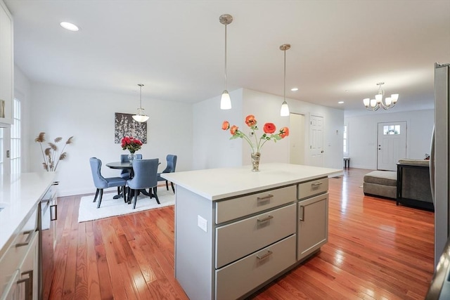 kitchen featuring a center island, light hardwood / wood-style floors, and hanging light fixtures