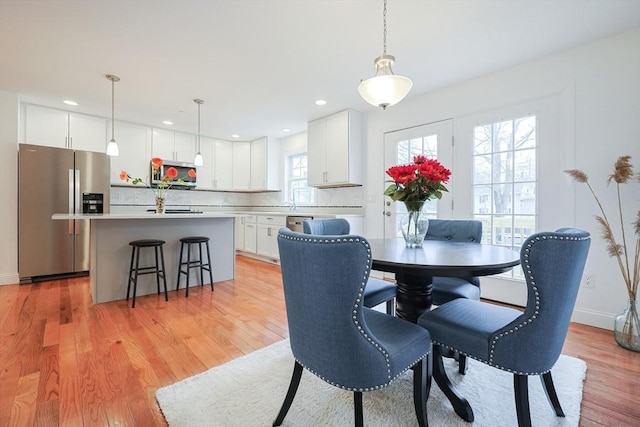 dining area featuring light wood-type flooring