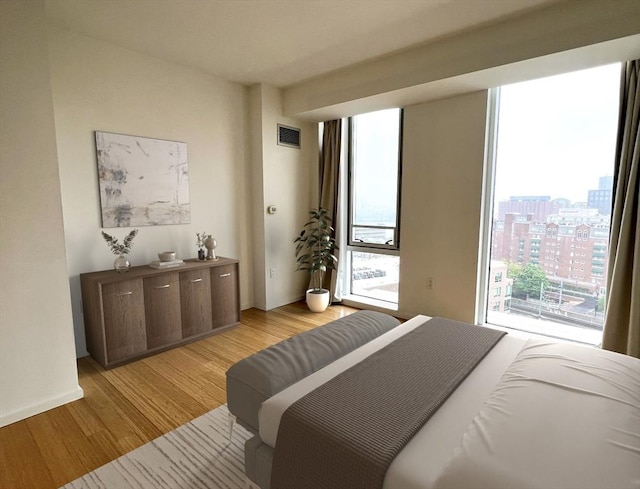 2 Earhart St Unit Ph6, Cambridge, MA 02141 - bedroom with multiple windows, light wood-style floors, and a city view