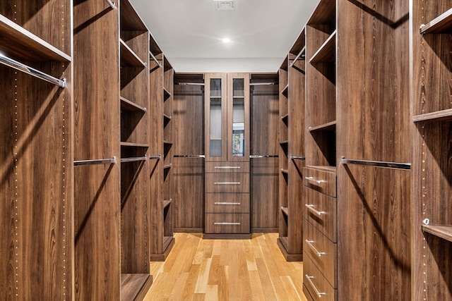 walk in closet featuring light hardwood / wood-style flooring