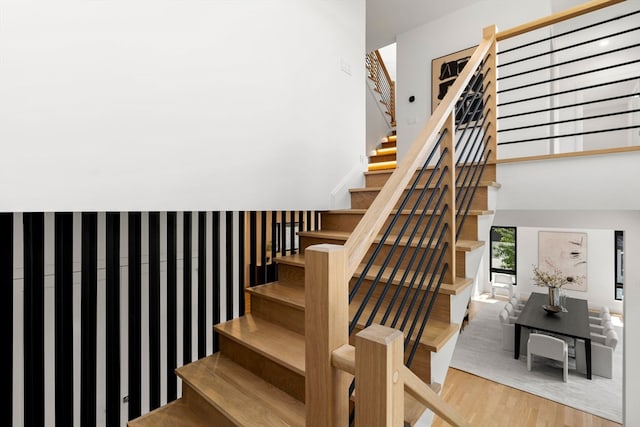 stairs featuring hardwood / wood-style floors