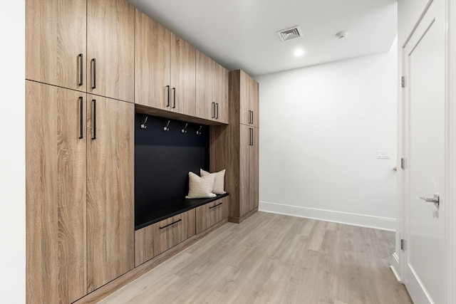 mudroom with light hardwood / wood-style flooring