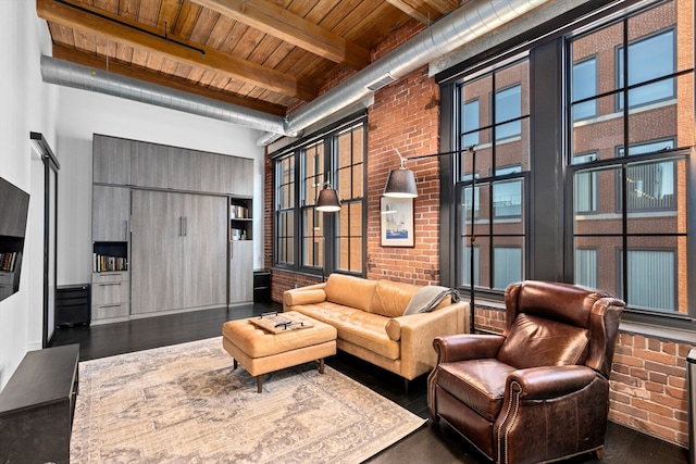 living room with a towering ceiling, wooden ceiling, and beamed ceiling