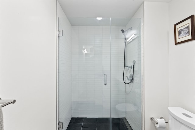 bathroom with toilet and an enclosed shower