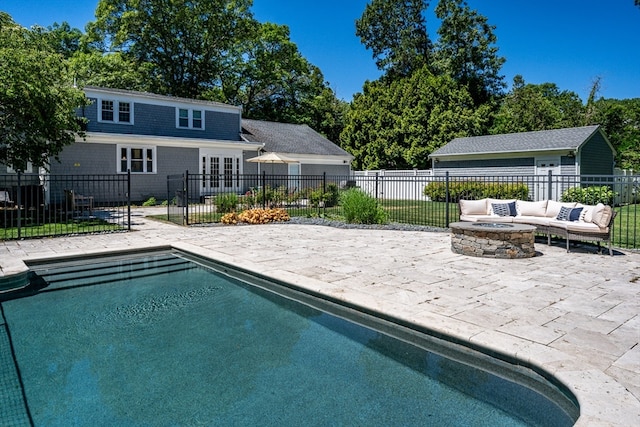 view of swimming pool featuring a patio and an outdoor fire pit