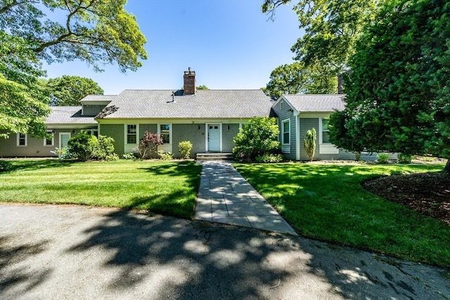 ranch-style home featuring a front yard