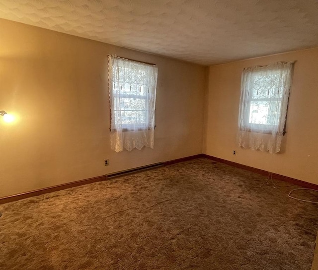 unfurnished room with carpet floors and a textured ceiling