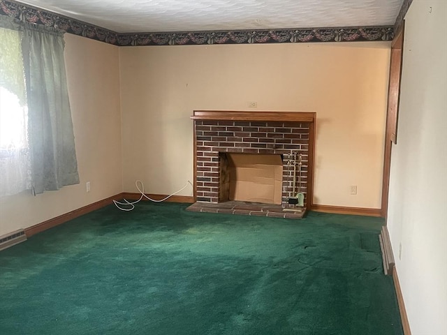 unfurnished living room with a textured ceiling, a fireplace, and dark carpet