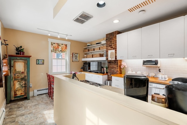 kitchen featuring white cabinetry, butcher block countertops, and a baseboard radiator