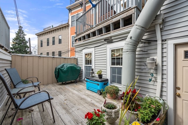 wooden deck featuring a grill