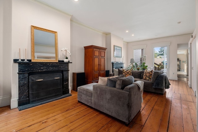 living room featuring ornamental molding and hardwood / wood-style floors