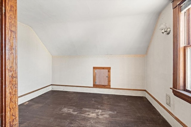 bonus room featuring vaulted ceiling, baseboards, and wood finished floors