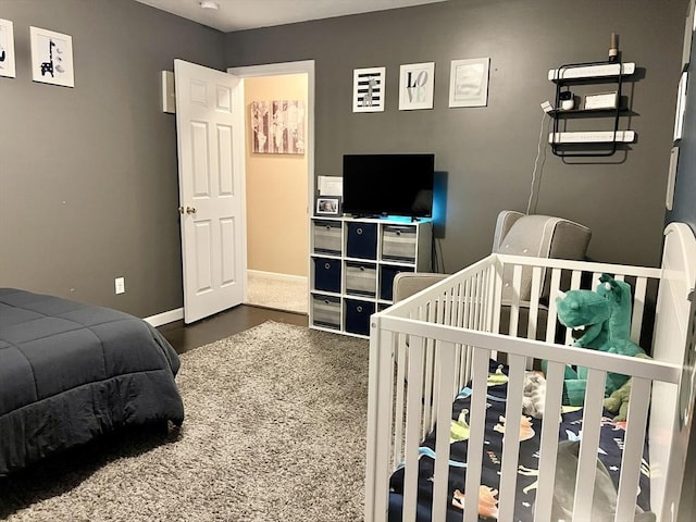 bedroom featuring a nursery area