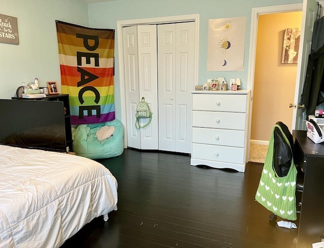 bedroom featuring dark hardwood / wood-style floors and a closet