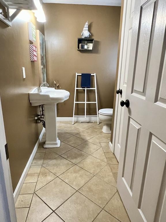 bathroom with sink, tile patterned flooring, and toilet