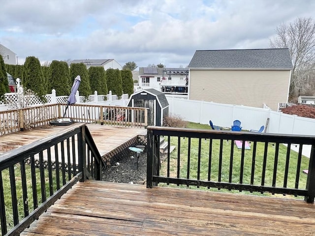 wooden terrace featuring a yard and a storage shed