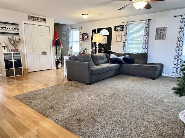 living room featuring ceiling fan and hardwood / wood-style floors