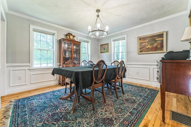 121 Adams Rd, East Brookfield, MA 01515 - dining area with a chandelier, wood finished floors, wainscoting, ornamental molding, and a decorative wall