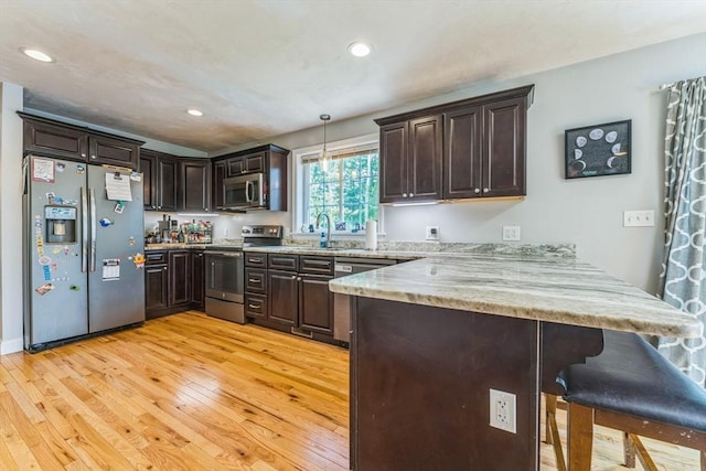 121 Adams Rd, East Brookfield, MA 01515 - kitchen with stainless steel appliances, a peninsula, light wood-type flooring, dark brown cabinetry, and recessed lighting