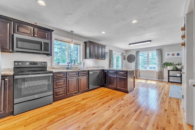 121 Adams Rd, East Brookfield, MA 01515 - kitchen featuring stainless steel appliances, light wood finished floors, dark brown cabinets, a peninsula, and recessed lighting