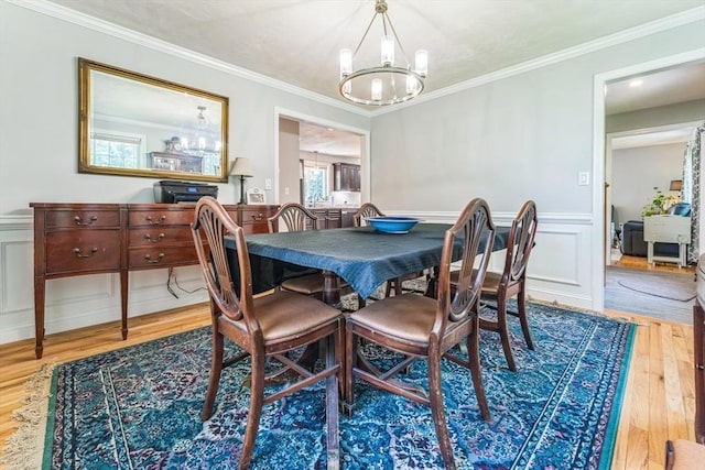 121 Adams Rd, East Brookfield, MA 01515 - dining room with a chandelier, wood finished floors, a wainscoted wall, crown molding, and a decorative wall