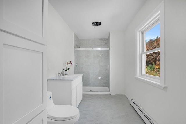 bathroom featuring vanity, toilet, a healthy amount of sunlight, and a shower with shower door