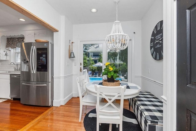 94 Circuit Rd, Winthrop, MA 02152 - dining room with light wood finished floors, a chandelier, and recessed lighting