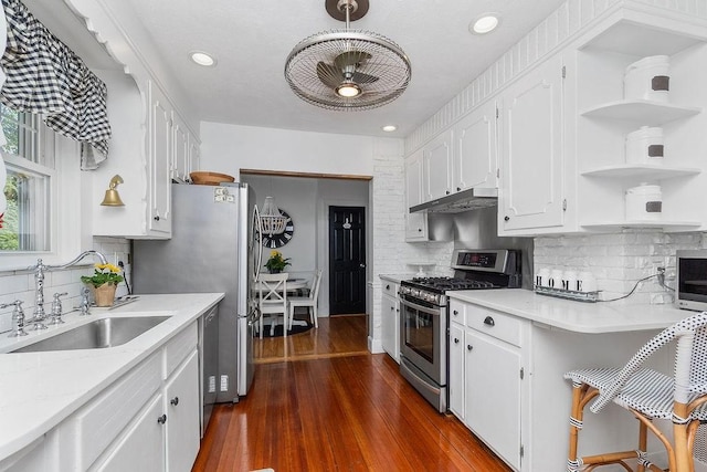 94 Circuit Rd, Winthrop, MA 02152 - kitchen with appliances with stainless steel finishes, open shelves, decorative backsplash, white cabinetry, and recessed lighting