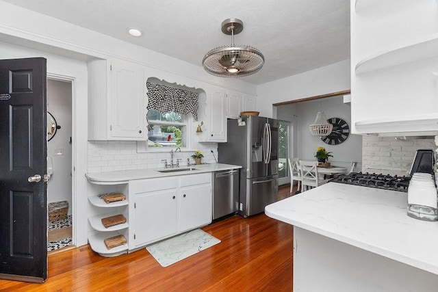 94 Circuit Rd, Winthrop, MA 02152 - kitchen with stainless steel appliances, open shelves, dark wood finished floors, tasteful backsplash, and white cabinets