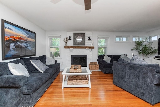 94 Circuit Rd, Winthrop, MA 02152 - living area with light wood-style flooring, a brick fireplace, and ceiling fan