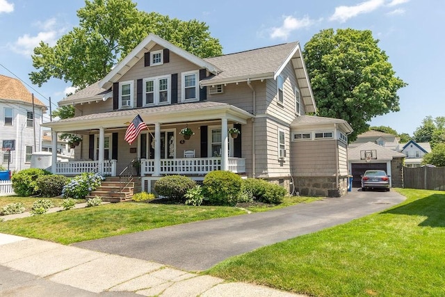 94 Circuit Rd, Winthrop, MA 02152 - view of front of house with covered porch, a shingled roof, and a garage