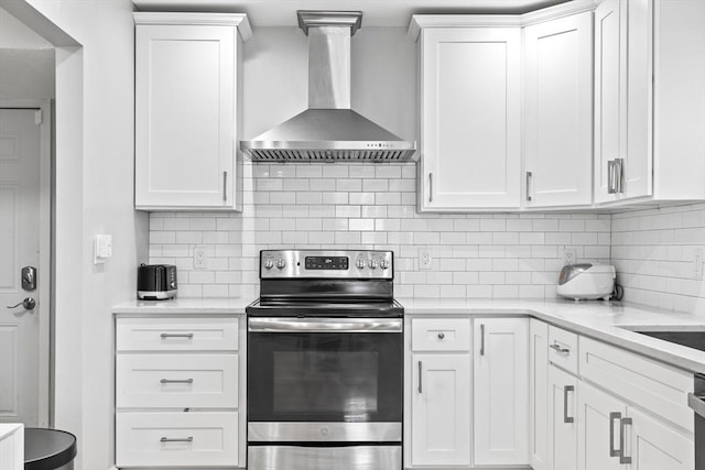 8 Nicholl St, Quincy, MA 02169 - kitchen featuring wall chimney range hood, stainless steel electric stove, white cabinetry, decorative backsplash, and light stone counters