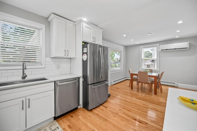 8 Nicholl St, Quincy, MA 02169 - kitchen with appliances with stainless steel finishes, an AC wall unit, baseboard heating, white cabinetry, and recessed lighting