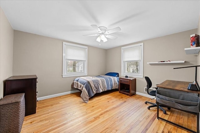bedroom with hardwood / wood-style floors, ceiling fan, and baseboards