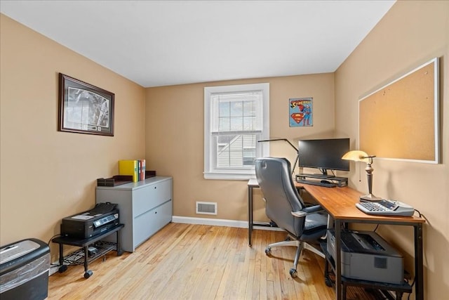 office space with light wood finished floors, baseboards, and visible vents